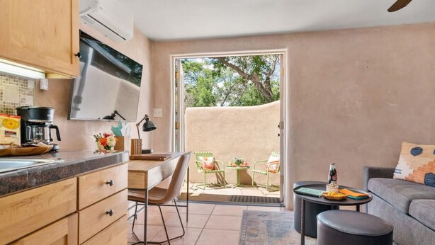 A compact living space with a kitchen, dining area, and a small patio. - Studio Near Santa Fe Farmers Market (Santa Fe)