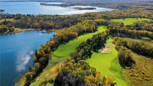 An aerial view of a golf course with water bodies and dense forests. - Winter, Spring, Summer or Fall, this place has it all! In Breezy Point Resort (Breezy Point)