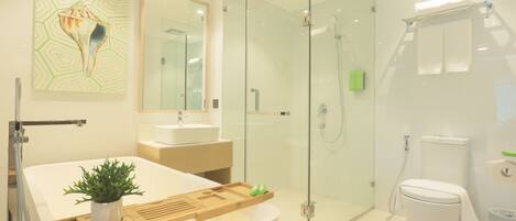 A modern bathroom with a glass-enclosed shower, a freestanding bathtub, and a large mirror.