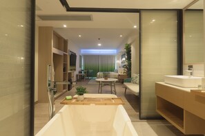 A modern bathroom with a bathtub, vanity, and a shower area. - Lime Resort El Nido (El Nido)