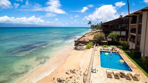 A beachfront hotel with a swimming pool, beach access, and ocean views.