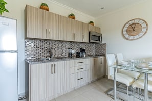 Fridge, microwave, stovetop, coffee/tea maker