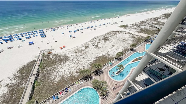 A resort with a beach, a pool area, and a view of the ocean. - Oasis, formerly Phoenix West II, New Owner, Beachfront and WaterSlide!! (Orange Beach)