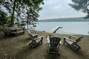 Relax on the lakeside dock, surrounded by trees and a serene shoreline.