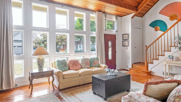 A living room with a beige sofa, a dark coffee table, and a patterned rug. - Bayfront to Beach Beauty Access to bay (Dewey Beach)