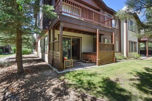 Enjoy a peaceful stay in this cozy cabin with a covered porch and balcony overlooking the serene surroundings.