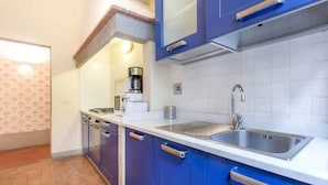 A kitchen with blue cabinets, a white countertop, and a stainless steel sink. - Reinassance Beauty - elegant apartment in the heart of Florence (Firenze)