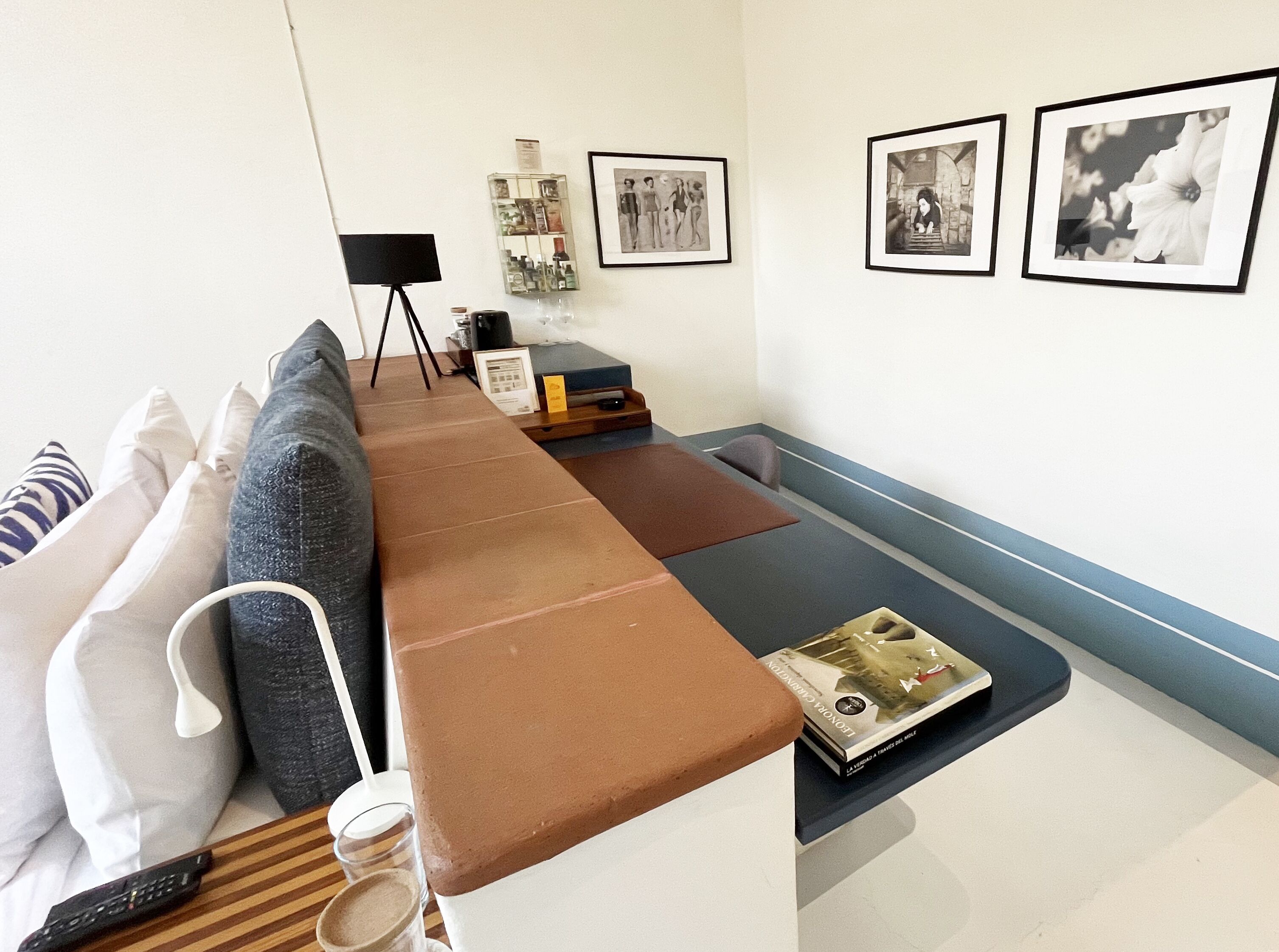 A modern living room with a sofa, a coffee table, and a bookshelf.