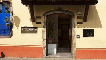 Enter El Circulo, a charming restaurant with a stone archway and a tiled roof.