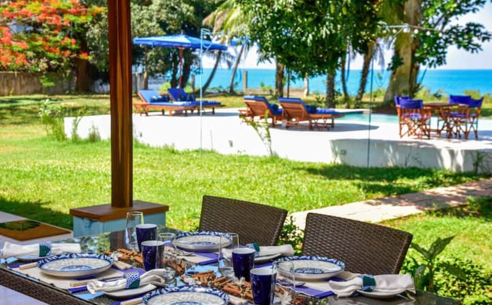 A table set for dining with blue and white plates, glasses, and cutlery.