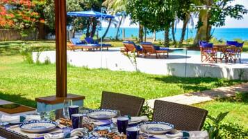 A table set for dining with blue and white plates, glasses, and cutlery.