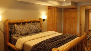 A wooden bed with a headboard, patterned pillows, and a blanket. - Spring thaw-summer is on the horizon!  (Annandale)