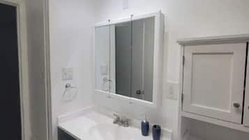 Combined shower/bathtub, hair dryer, towels, toilet paper