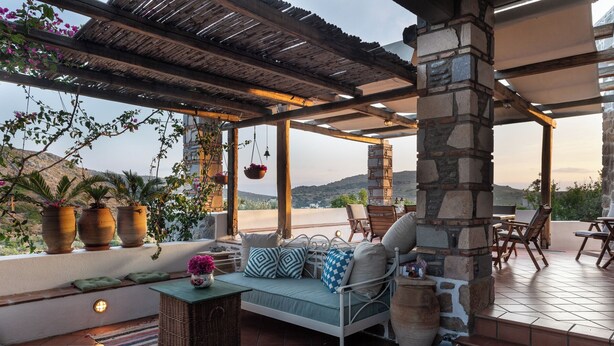 A cozy outdoor seating area with a sofa, chairs, and potted plants. - Blue Vista Patmos Villa Margarita without the studios (Patmos)