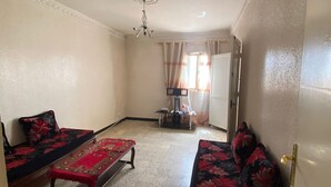 A living room with two sofas, a coffee table, and a ceiling fan.