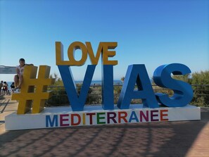 A large outdoor sign with the words "LOVE VIAS" and "MEDITERRANEE" in bold letters. - Air-conditioned villa, 300 m from Farinette Beach (Vias)