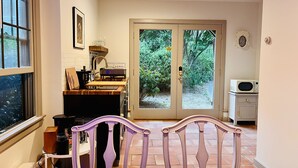 A kitchen with a wooden countertop, a sink, and a window. There is a door leading outside. - Private Cape Cod Cottage. Walk to Ellis Landing Beach! (Brewster)