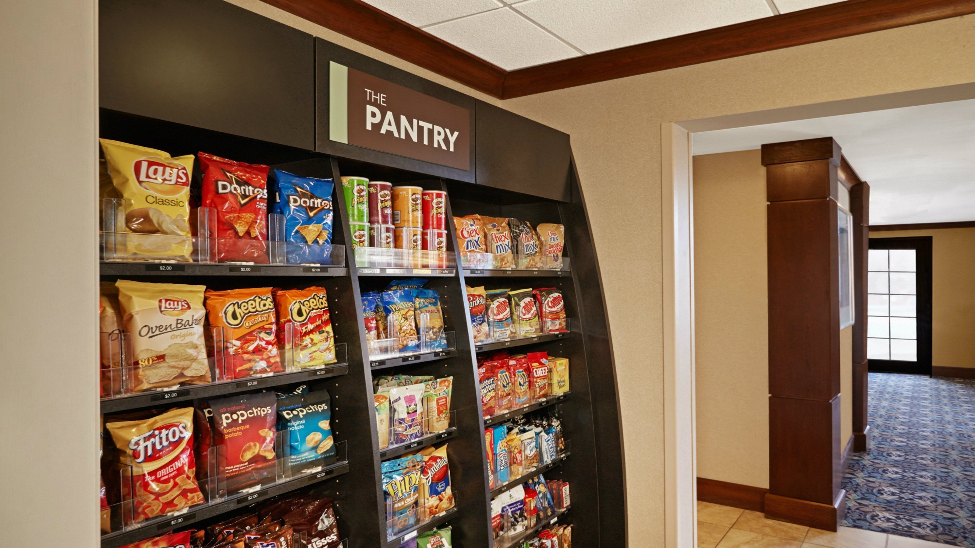 A pantry stocked with various snacks and beverages.