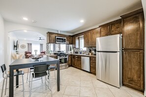 Enjoy cooking in this well-lit kitchen with a central island and stainless steel appliances.