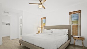 A bedroom with a bed, a nightstand, a ceiling fan, and a window with blinds. - Your Private Tropical Paradise with Heated Pool! (Sarasota)