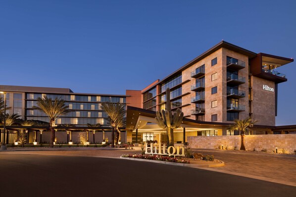 A multi-story hotel with a prominent "Hilton" sign, featuring balconies and a modern architectural design. - Hilton North Scottsdale At Cavasson (Scottsdale)