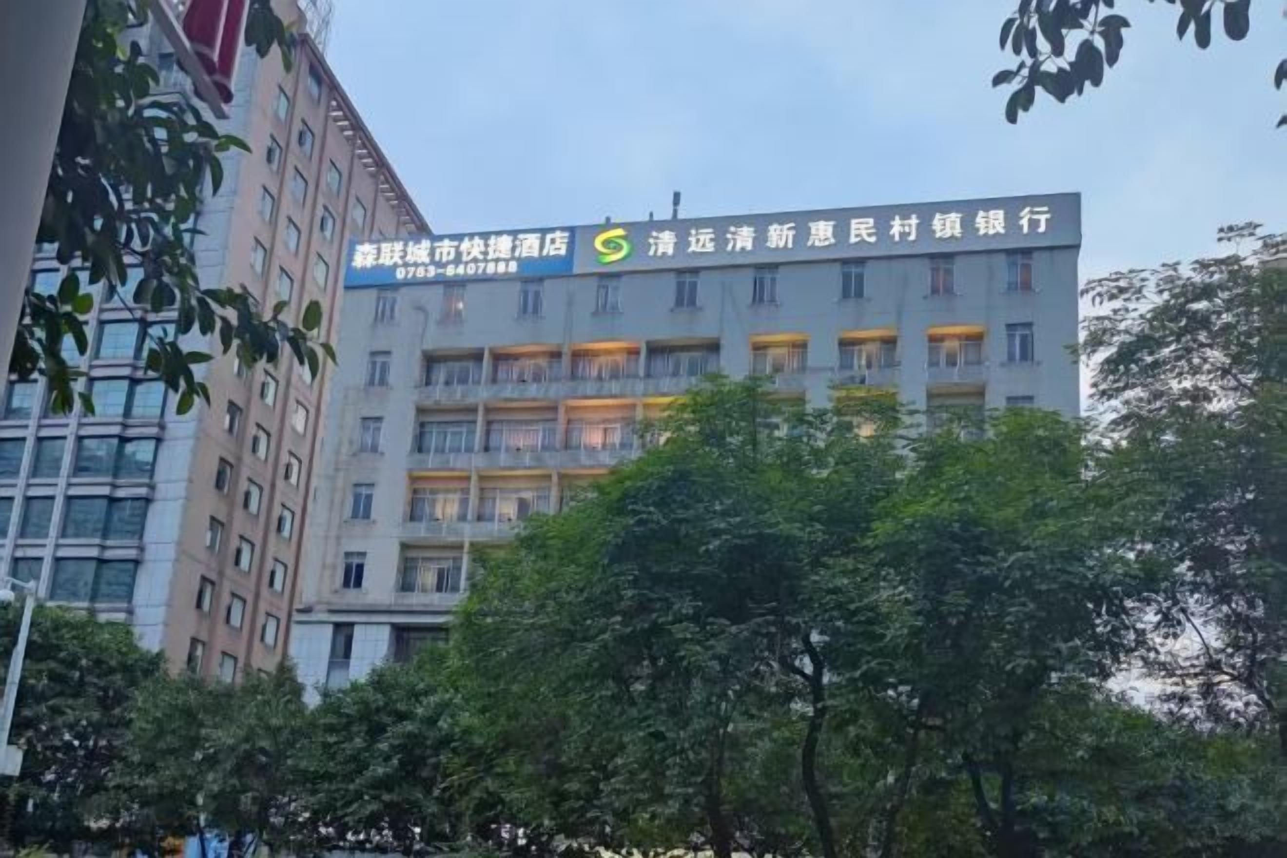 A multi-story building with a sign indicating it is a hotel.