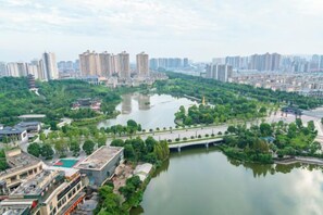 A riverside view with a bridge, buildings, and greenery. - Lihao Hotel (Chongqing Yongchuan High-speed Railway Station) (Chongqing)