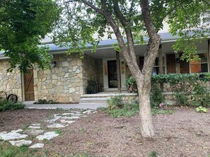 Classic stone facade with a traditional entrance and beautifully maintained garden.