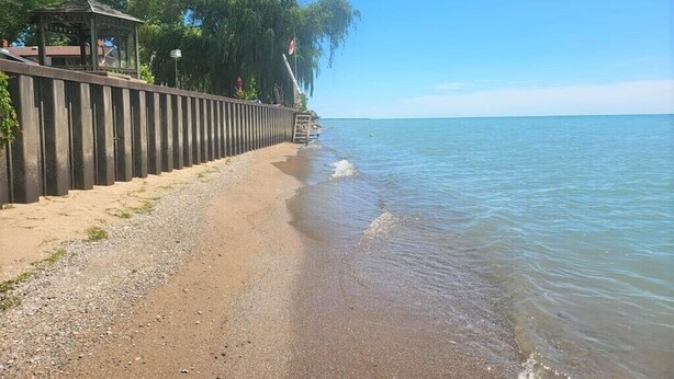 A beach with a wooden walkway and a gazebo. - 80 Feet of Private Lakefront House (Amherstburg)