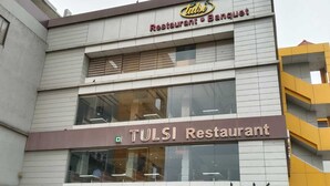 A TULSI Restaurant with a signboard for "11 JAY SANTOSHI MAA 11" below it. - Hotel Tulsi (Surat)