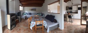 Cozy room with a dining area, sofa, and fireplace, perfect for relaxing and enjoying meals.
