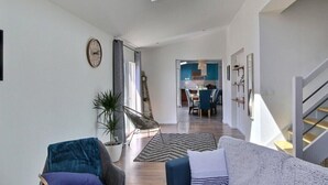 A spacious living area with a skylight, a dining area, and a staircase. - So Chic Kerfily, un Petit Coin de Paradis Breton Avec Espace SPA (Locmaria-Plouzané)