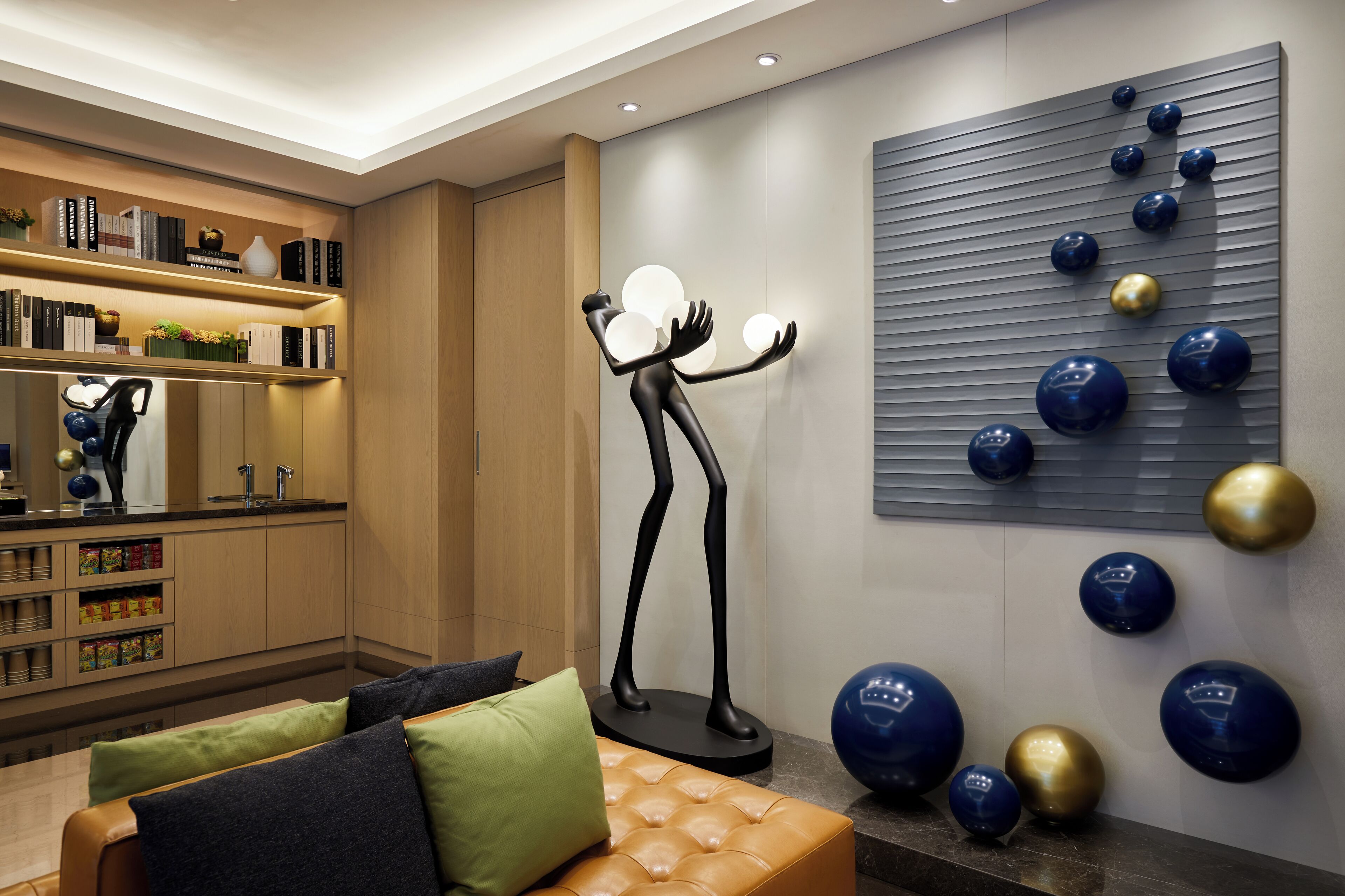 A modern living room with a sofa, a coffee table, and a decorative sculpture.