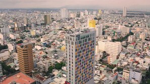 A densely packed urban area with high-rise buildings, including a prominent building with 'WINK' signage.