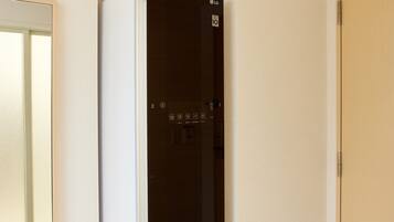 A modern, dark-colored refrigerator with a control panel and a visible brand logo.