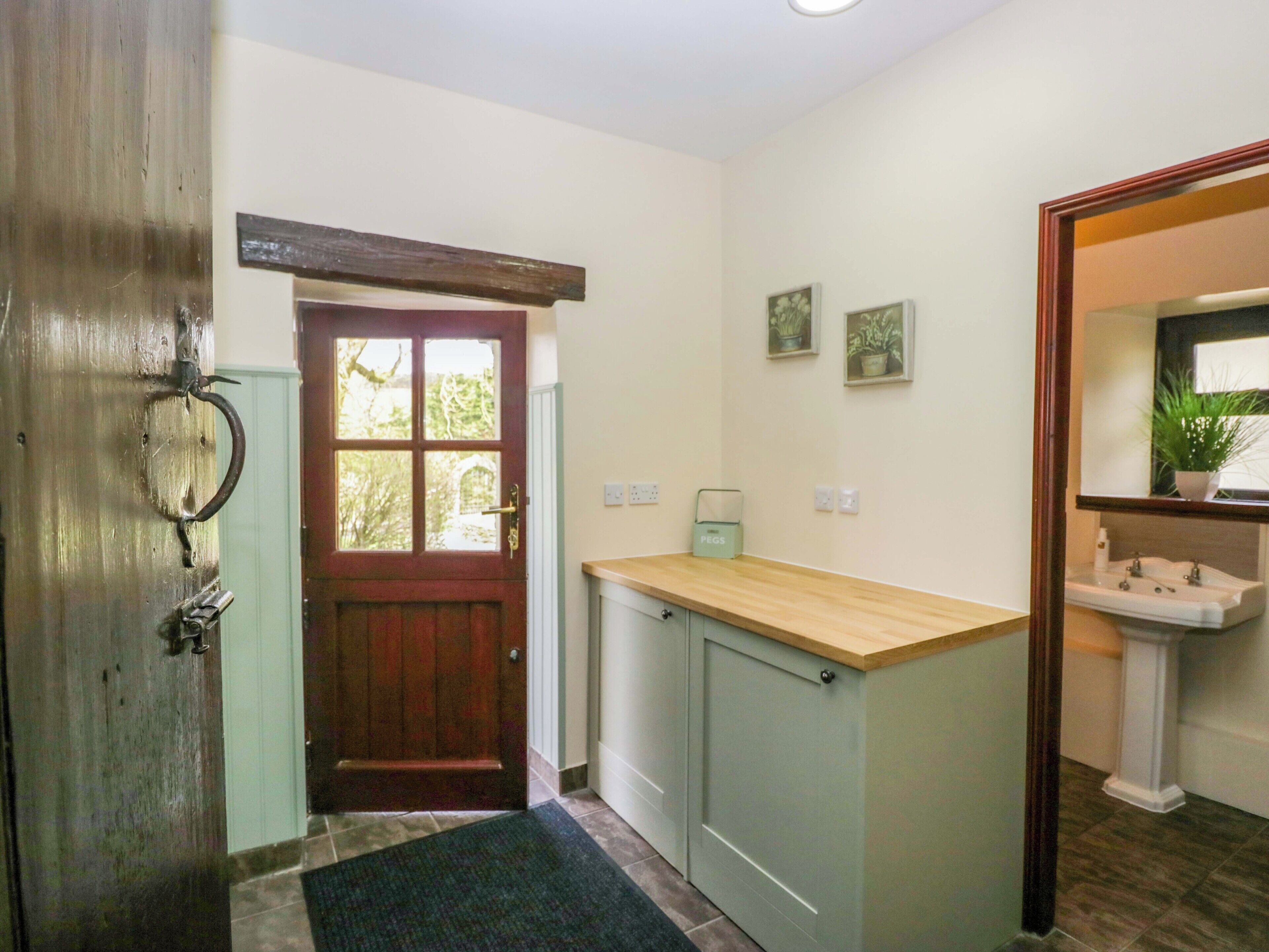 A kitchen with a wooden door, a sink, and a countertop.