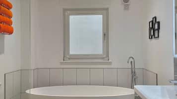 Bathtub, hair dryer, towels, soap