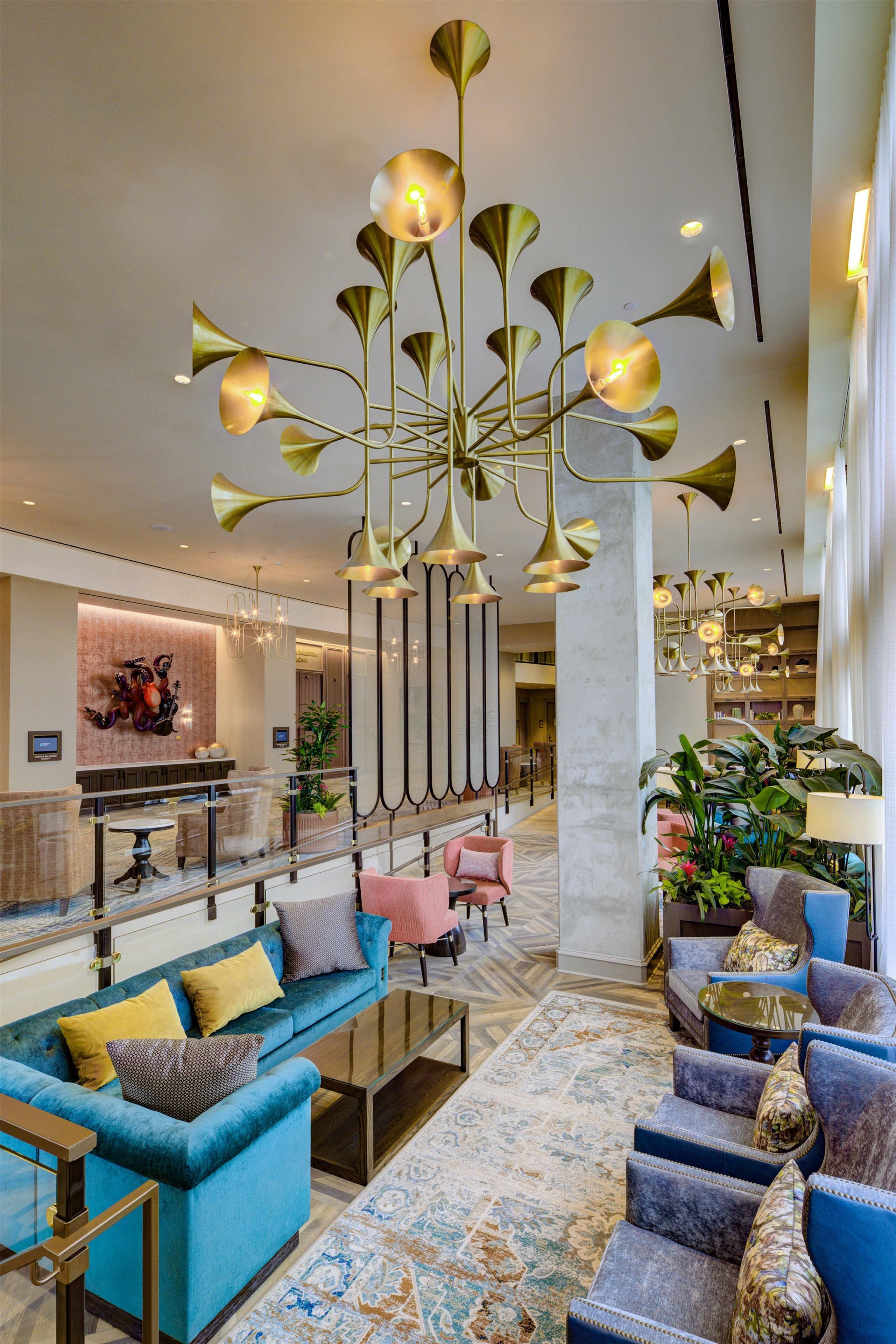 A spacious lobby with a blue sofa, a coffee table, and a patterned rug.