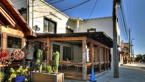 A building with a sign reading "Hunter on Main" and a covered outdoor seating area with plants and a blue cone. - Modern Penthouse Suite in historic downtown Blue Ridge, GA (Blue Ridge)