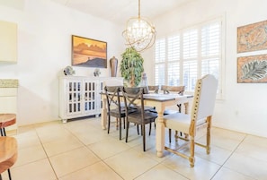 Enjoy meals in this elegant dining area with a large window, a dining table, and comfortable seating for four.