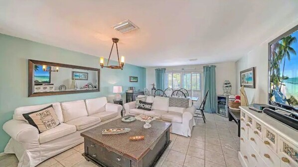 A living room with a sofa set, a coffee table, and a TV. - Perfect cottage! Million dollar views (Longboat Key)