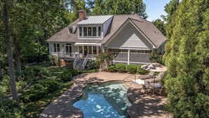 A house with a large backyard, a swimming pool, and a covered patio area. - Waterfront Bay Home, Amazing Water Views, with Private Saltwater Pool (Heathsville)