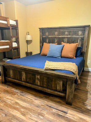 A bedroom with a wooden bed, a nightstand, a lamp, and a wooden ladder. - Large Family Alert-Walk-In Lakeview-Sleeps 9-Pools-Near Silver Dollar City (Branson)