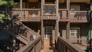 A multi-story building with a wooden exterior, balconies, and a central staircase. - Large Family Alert-Walk-In Lakeview-Sleeps 9-Pools-Near Silver Dollar City (Branson)