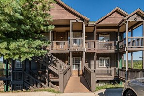 A multi-story wooden building with balconies and a staircase.