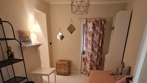 Une chambre à coucher avec un lit, un bureau, une chaise, une lampe et un miroir.