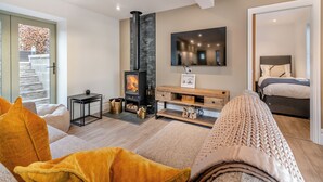 A modern living room with a fireplace, a TV mounted on the wall, and a cozy seating area. - 3 bedroom accommodation in Scaling Dam, near Whitby (Scaling Dam, near Whitby)