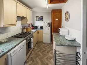 Hillside kitchen leading to private outdoor patio area | Hillside - Gairloch Cottages - Hillside, Gairloch