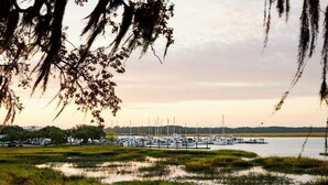 A marina with boats docked and a water body in the foreground.