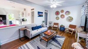 A modern living room with a sofa, coffee table, and decorative wall art.